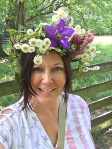 A woman wearing a flower crown on top of her head.